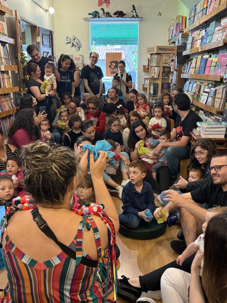Crianças e famílias assistindo à contação de histórias na Dia das Crianças Gaia 2025, evento da Clínica Mamma Gaia